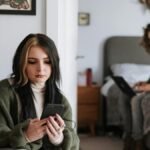A young couple on smartphones and laptop, focusing on digital connection.
