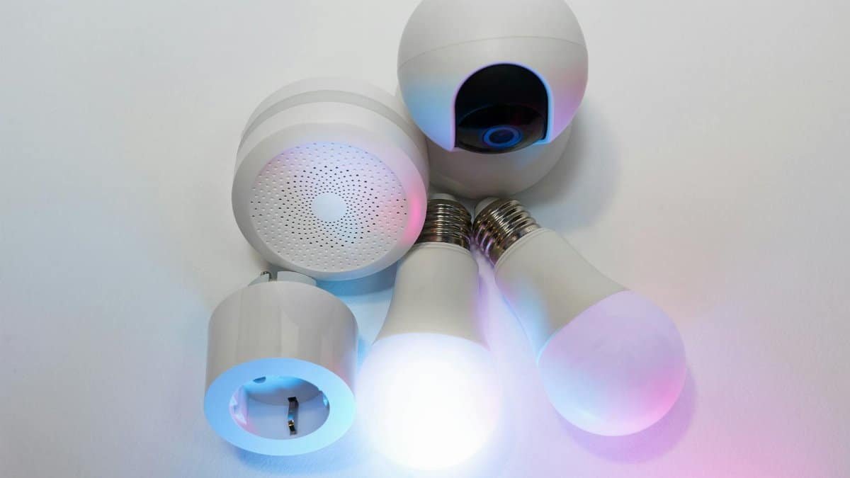 A collection of smart home devices including light bulbs, a security camera, and a smart hub.
