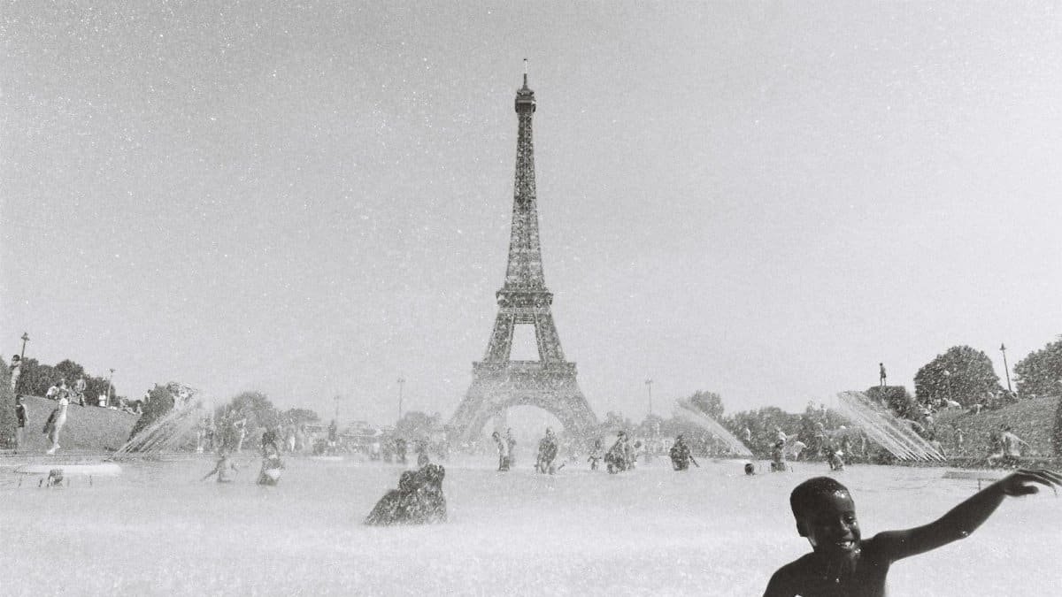 Children playing in fountains near Eiffel Tower in Paris, summer.