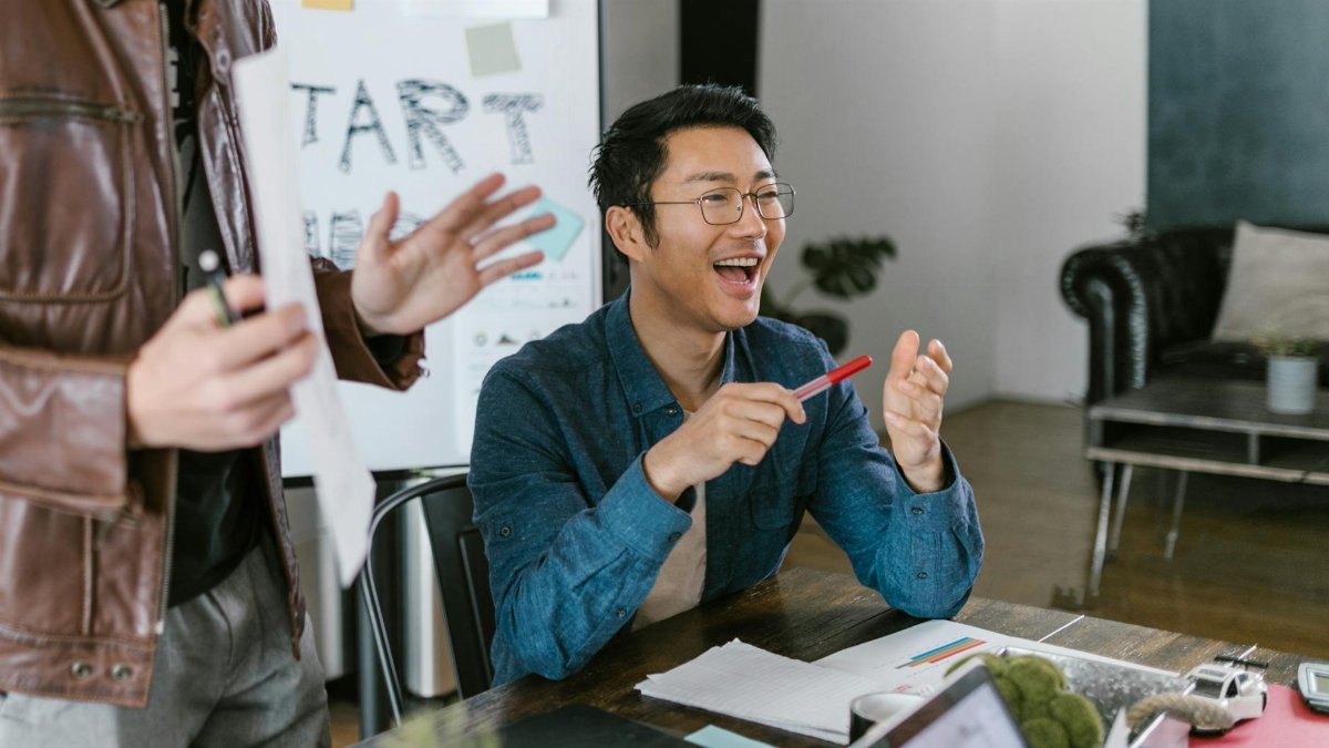 Engaged team members in a lively office meeting discussing startup ideas and innovation.