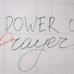 Handwritten 'Power of Prayer' message on a tiled surface conveying spirituality and inspiration.
