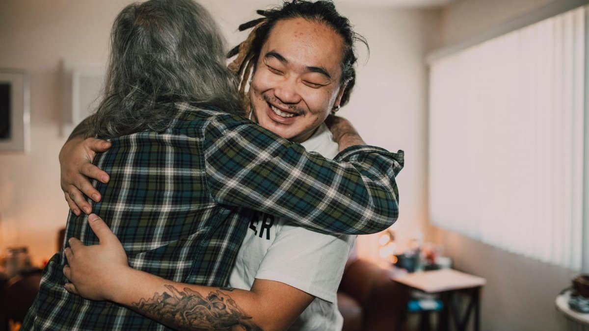 A joyful hug between friends in a cozy room, capturing warmth and friendship.