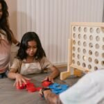 A family enjoys a cozy game night at home, connecting over a board game.