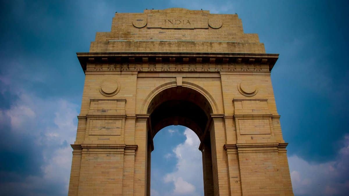 Majestic view of India Gate under a vibrant blue sky in New Delhi, India.