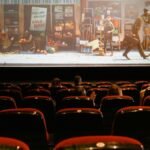 A cozy indoor movie theater showing an animated film to a small audience.