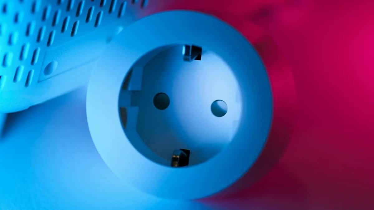 Close-up of a smart socket with vibrant blue and pink neon lighting, showcasing modern technology.