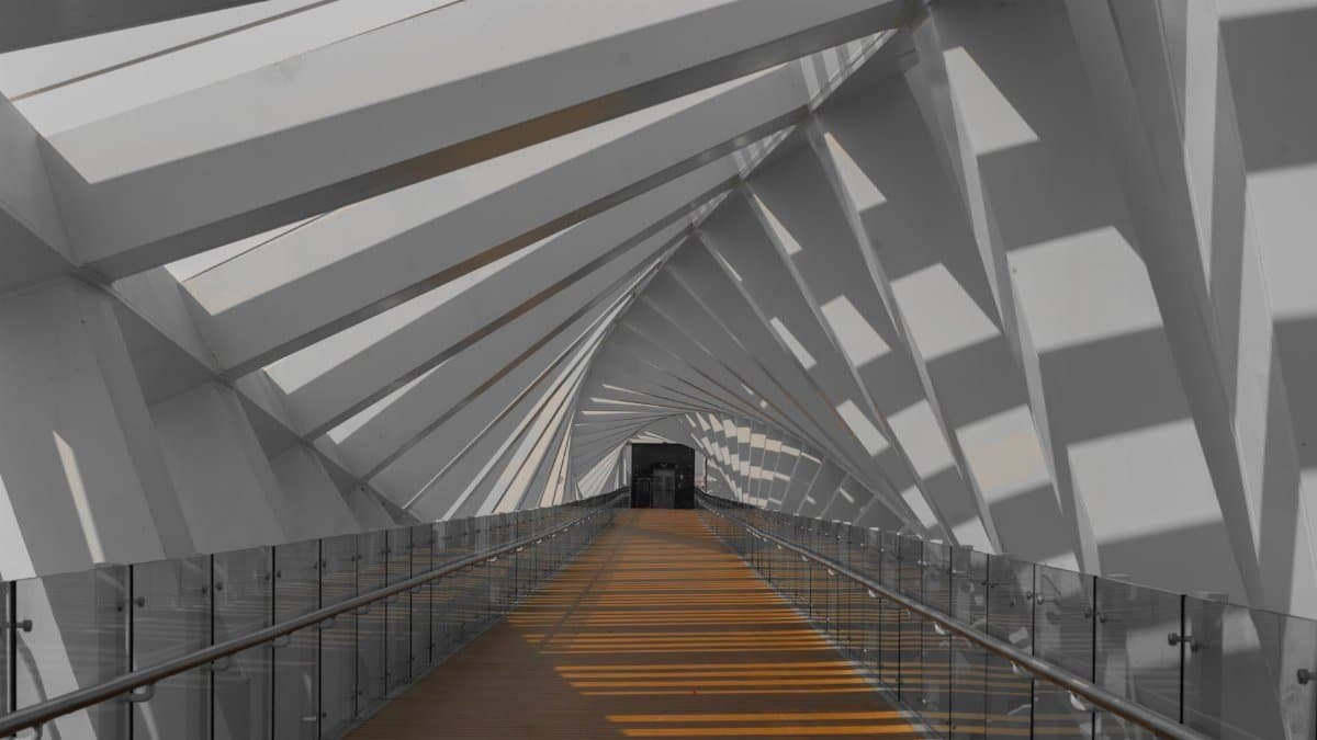 Explore a modern corridor with striking geometric designs and natural light streaming through.