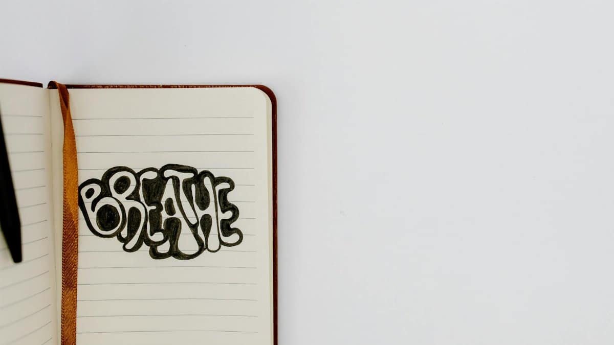 Open notebook with 'Breathe' written in bold letters, offering inspiration and copyspace.