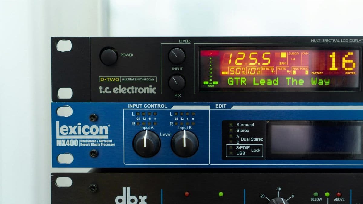 Stacked audio processors in a studio rack with digital displays and controls.