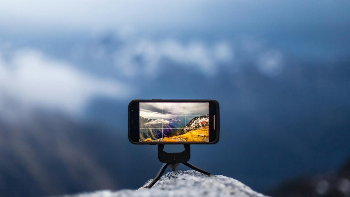 Smartphone on tripod capturing a stunning mountain vista in crisp focus and vibrant colors.