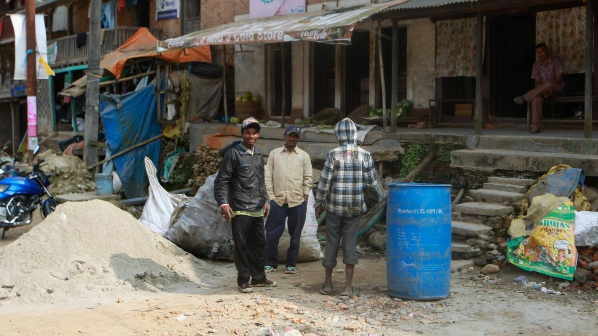 Urban street scene with workers and construction materials, capturing daily life.