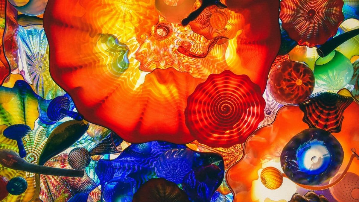 A vivid display of colorful abstract glass art with dynamic shapes and lighting.