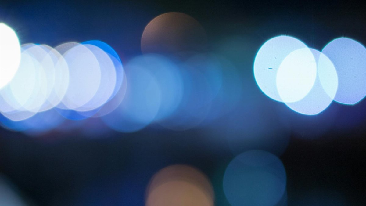 Blurred blue bokeh lights creating an abstract and dreamy visual effect.