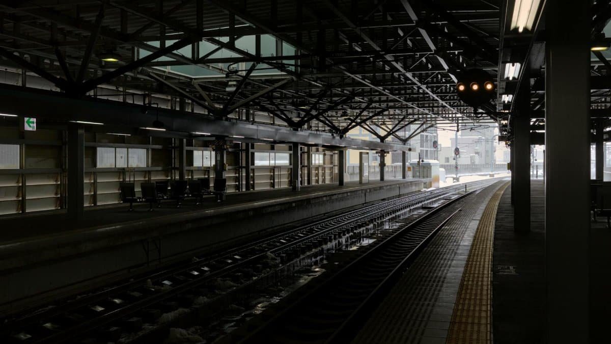 A quiet, empty train platform at Tsuruga Station, Fukui, Japan during winter.