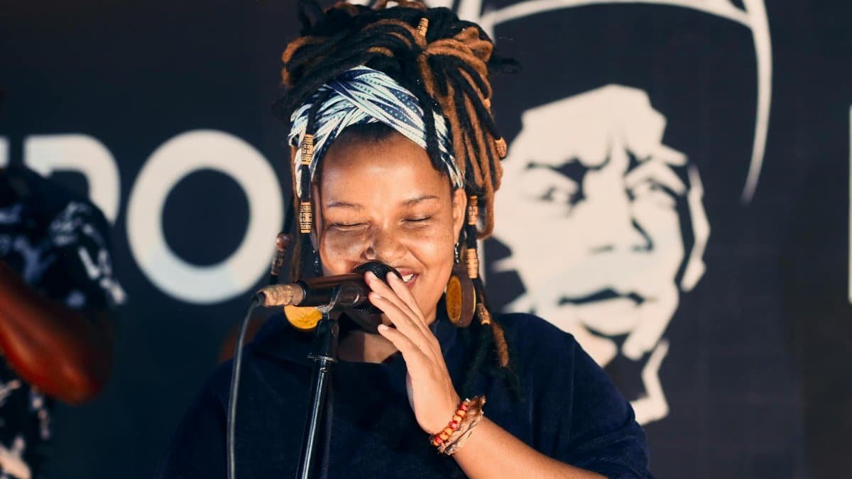 Vibrant performance by a female singer in Johannesburg, showcasing cultural style and joyous expression.