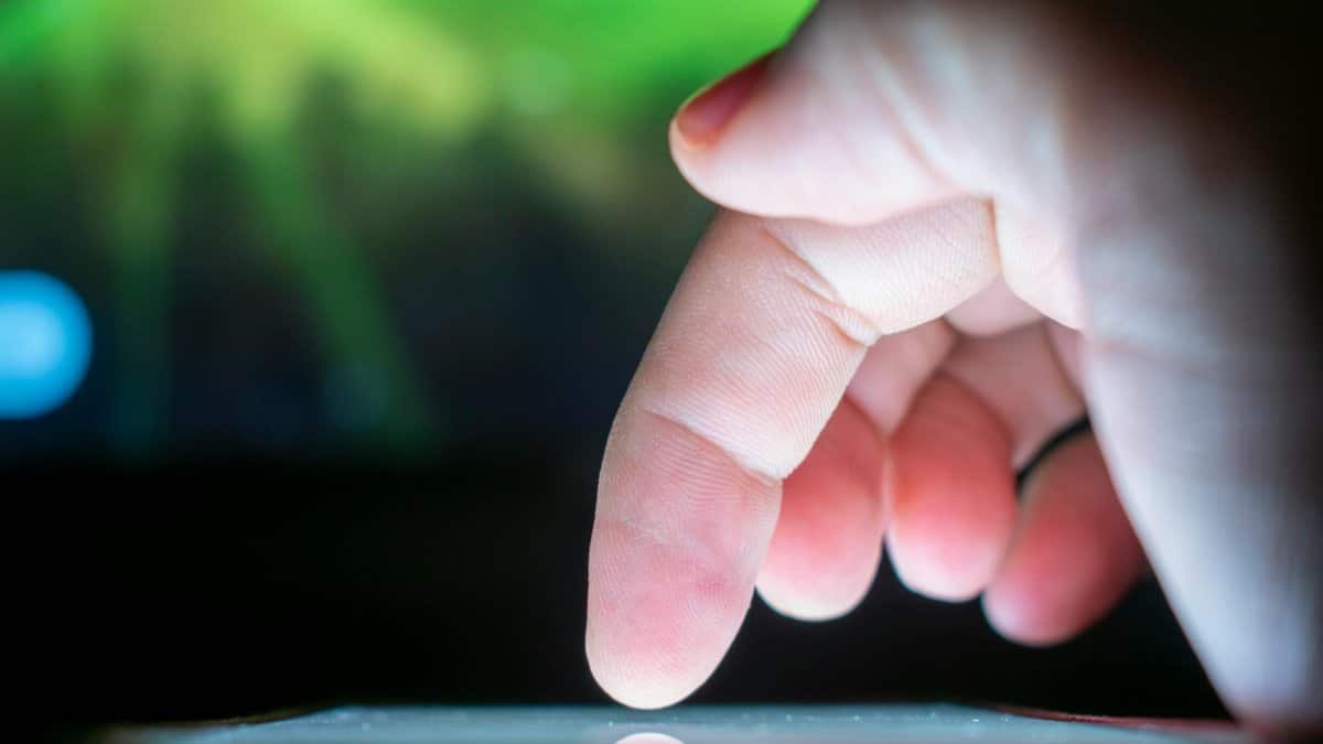 Close-up of a finger interacting with a touchscreen, capturing a moment of technology use.
