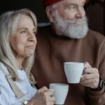 A senior couple embraces while enjoying coffee, symbolizing love and companionship.