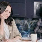 Couple experiencing stress while managing household finances at home.