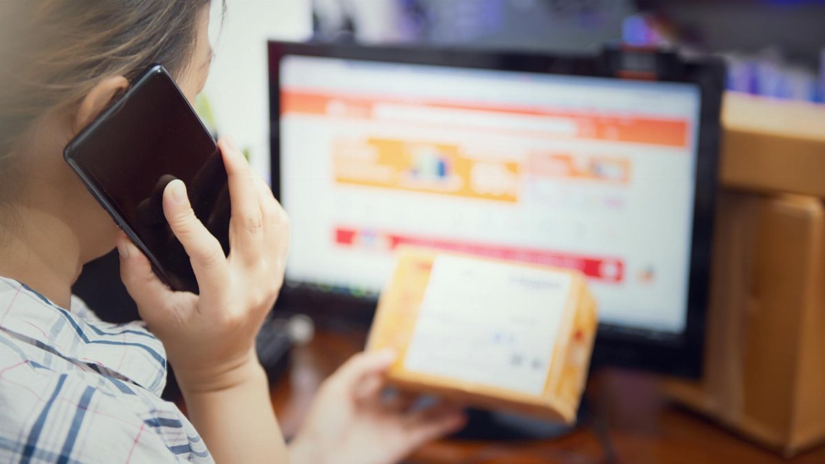 woman use mobilephone after recive box from online shopping. selective focus