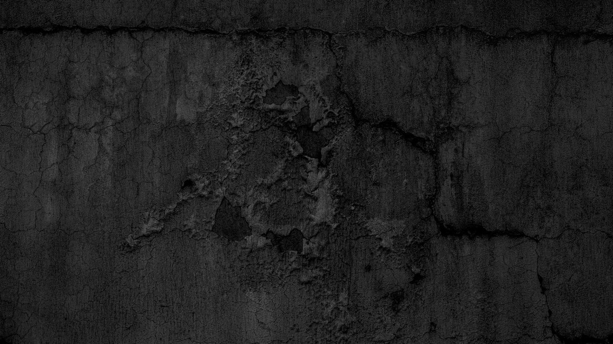 A textured close-up of a dark grunge concrete wall, perfect for backgrounds.