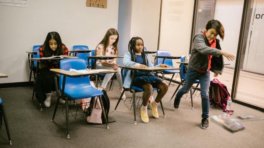 Students in a classroom experiencing a bullying situation among peers.