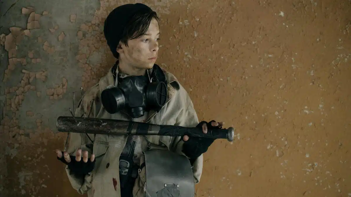 Teen holding a melee weapon with a post-apocalyptic theme. Worn and rough environment.