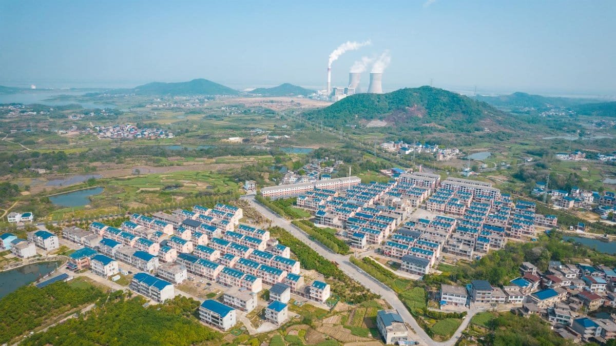 Drone view of suburban houses and a power plant in Jiujiang, Jiangxi Province, China.