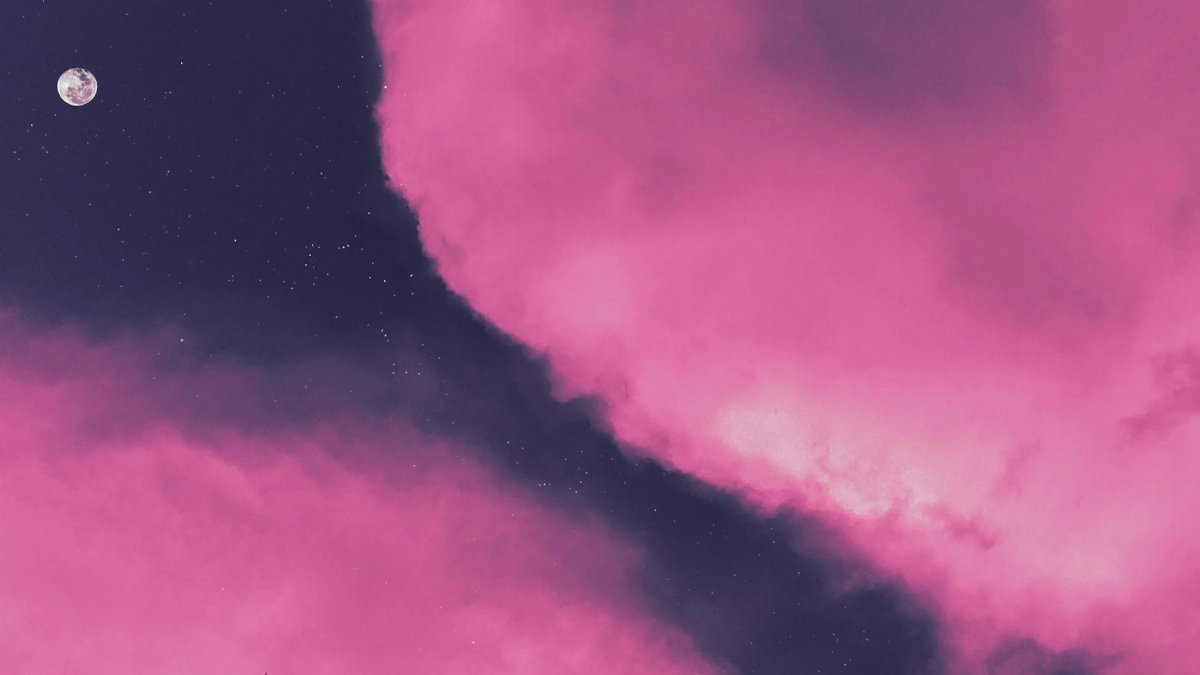 A mesmerizing view of pink clouds with the moon and stars, perfect for backgrounds.