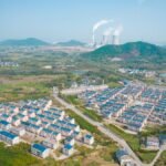 Drone view of suburban houses and a power plant in Jiujiang, Jiangxi Province, China.