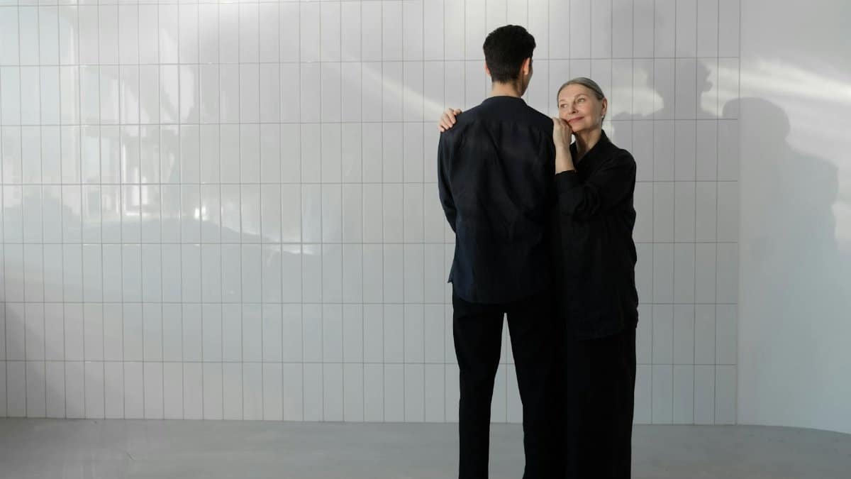 An affectionate embrace in a minimalist studio conveying warmth and tenderness.