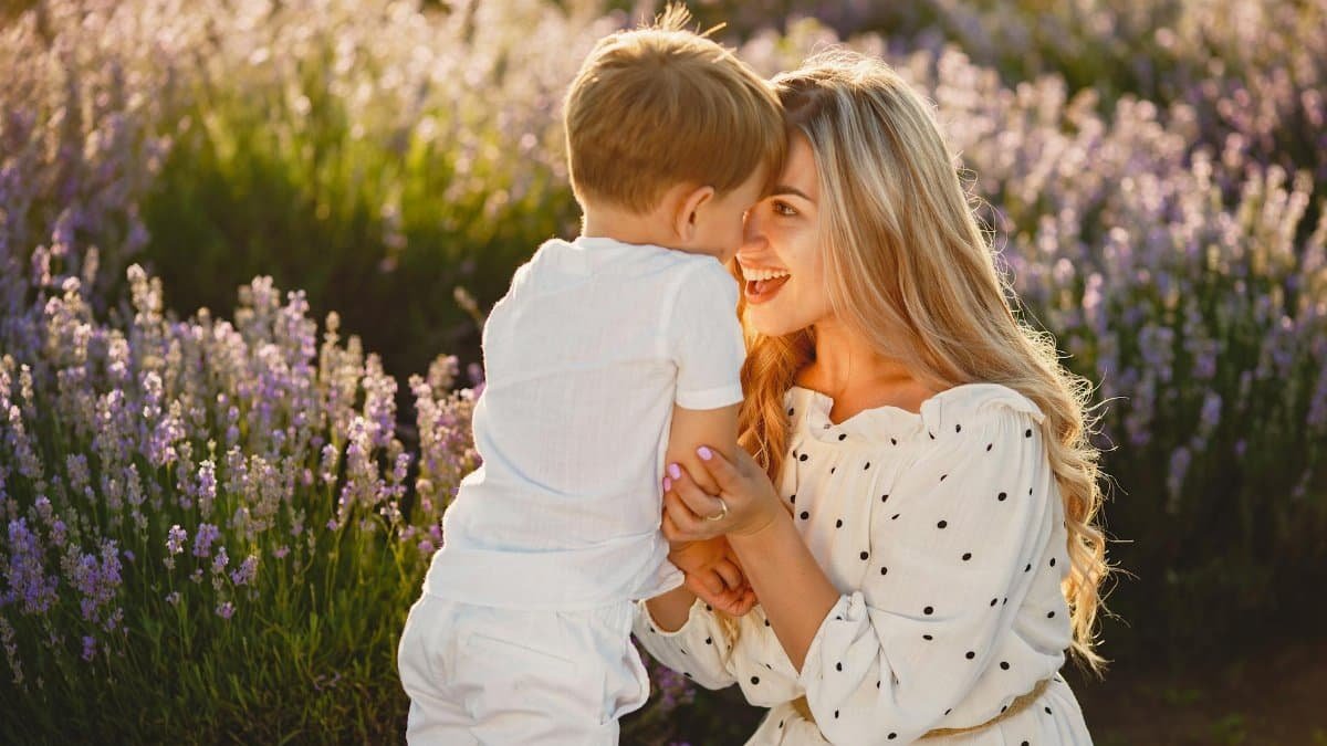 A joyful moment between mother and child in a lavender field, capturing love and happiness.