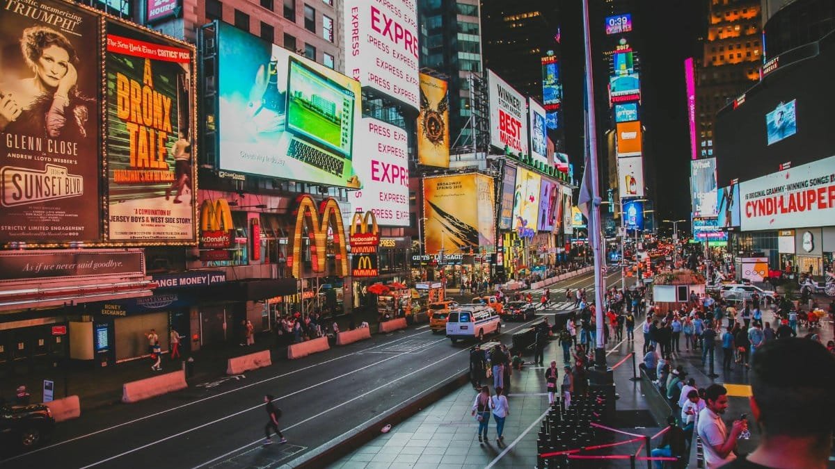 Dynamic view of Times Square nightlife with crowds and illuminated billboards in New York City.