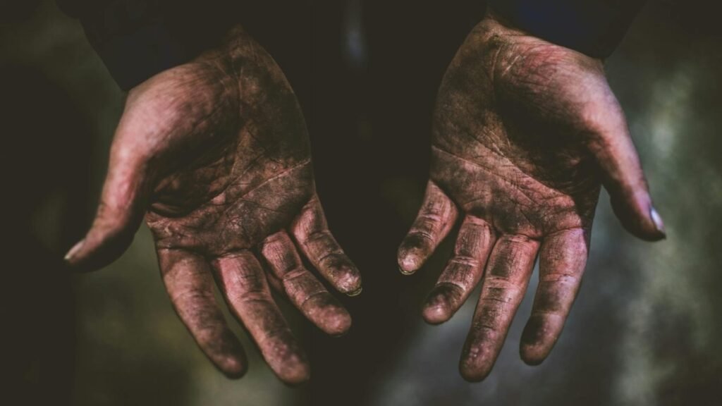 Close-up of dirty hands representing hard work and labor in Frankfurt.