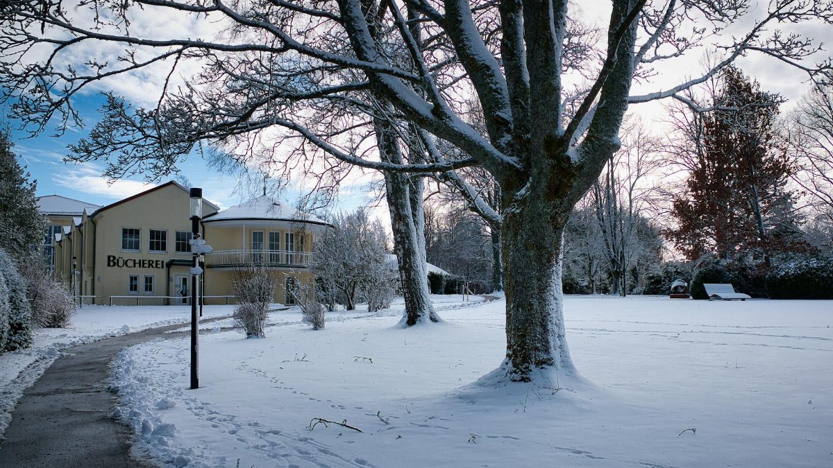 Serene winter scene with a snow-covered library in Schömberg, Germany.