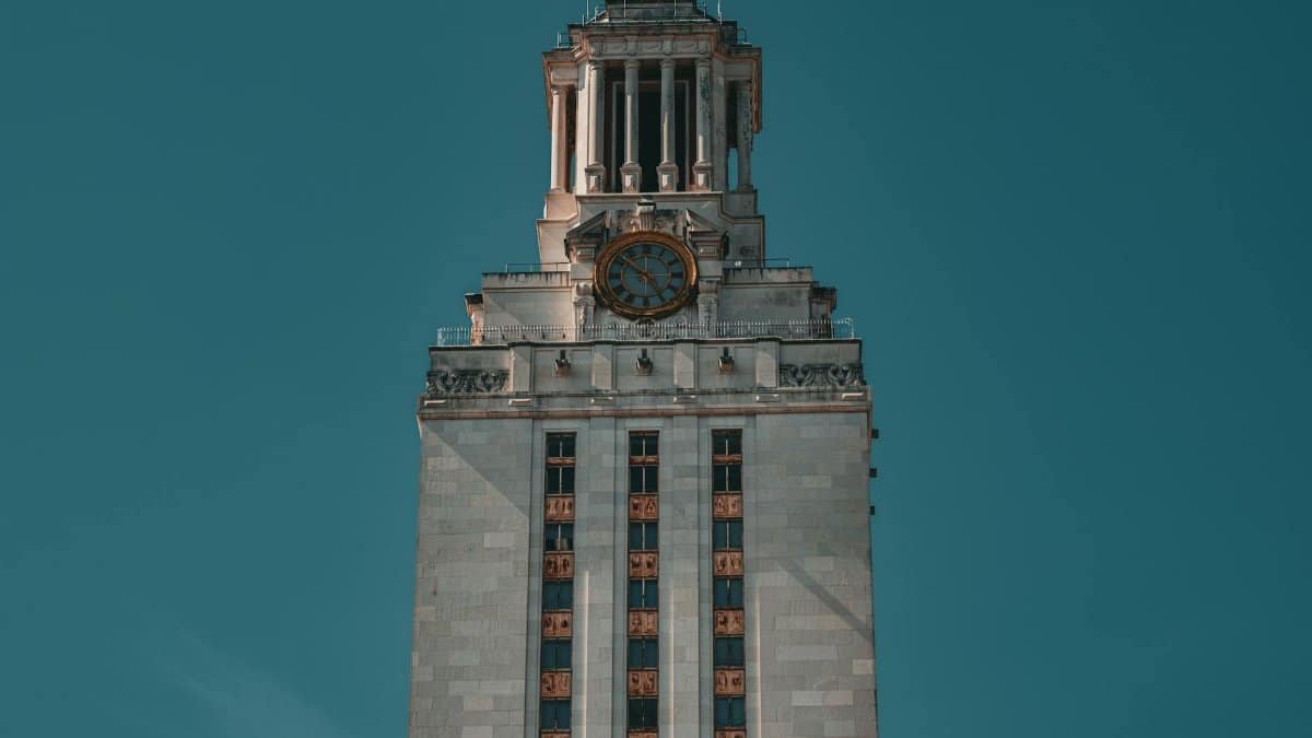 The University of Texas Tower against a clear blue sky in Austin, Texas.