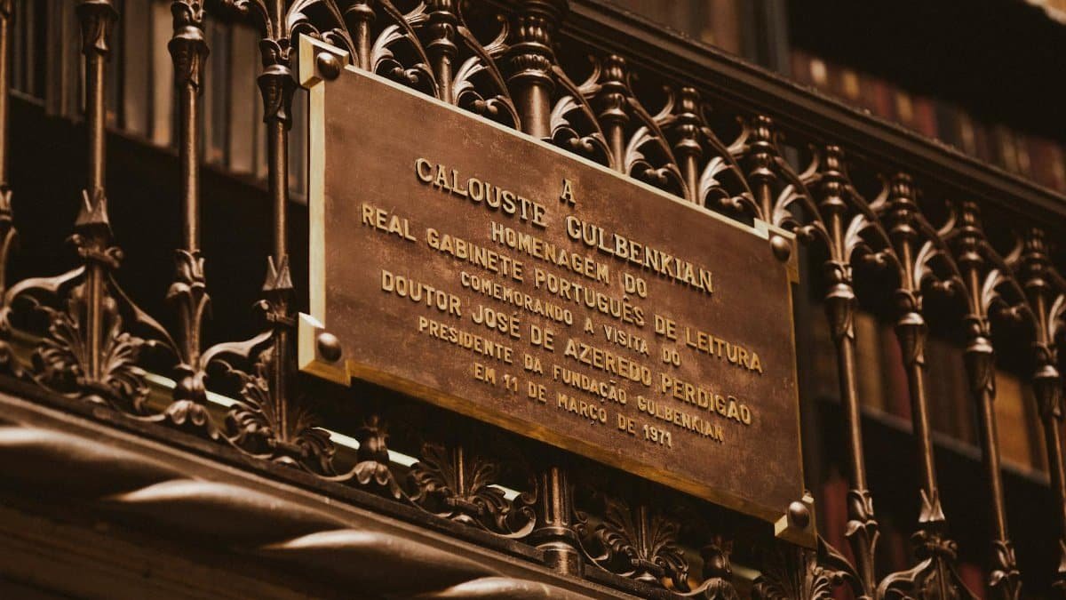 Close-up of a historic plaque honoring Calouste Gulbenkian at a library.