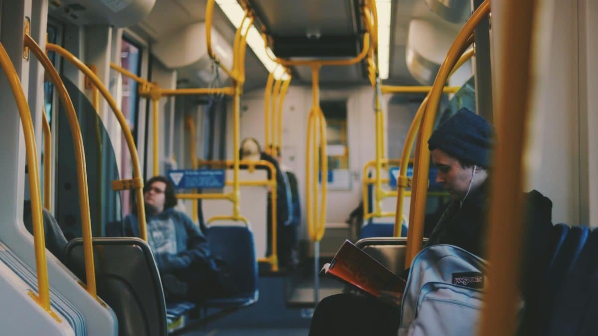 Commuters engaging in reading and relaxing on a modern Portland tram.