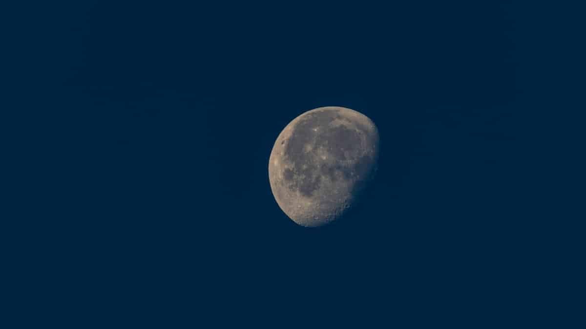 Close-up view of a waning gibbous moon against a dark night sky, showcasing lunar details.