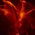 Dynamic abstract image of vibrant orange flames against a dark backdrop, exuding energy and warmth.