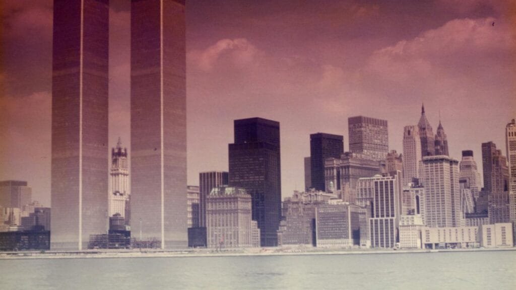 Vintage view of Manhattan skyline featuring the Twin Towers and surrounding skyscrapers across the water.