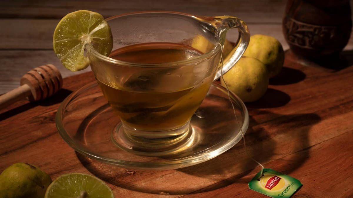 Close-up of lemon tea with honey on a wooden surface, evoking warmth and comfort.