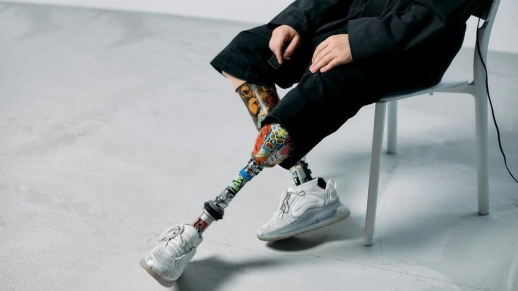 Colorful prosthetic legs in a minimalist studio, showcasing innovation and technology.