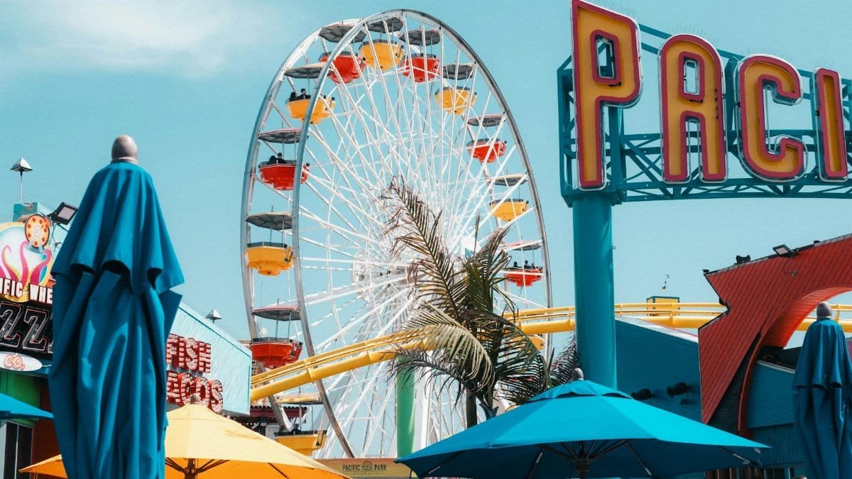 Colorful Ferris wheel and Pacific Park sign at Santa Monica Pier, Los Angeles.