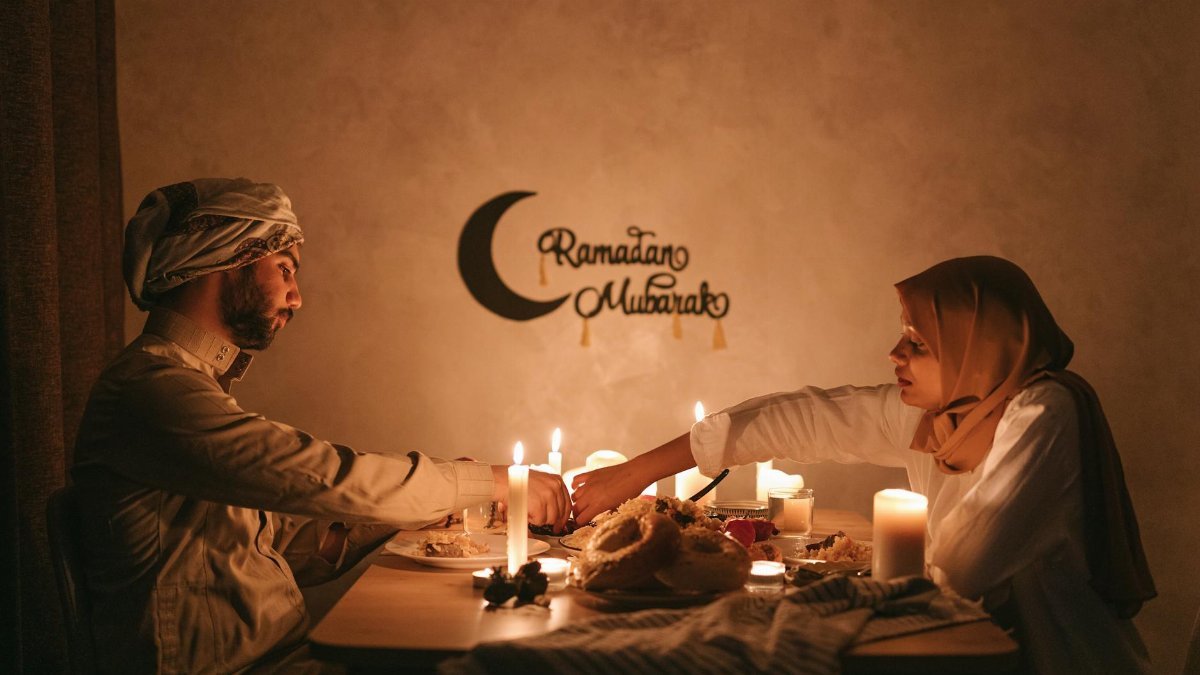 Couple enjoying iftar meal during Ramadan by candlelight, creating a warm and serene ambiance.