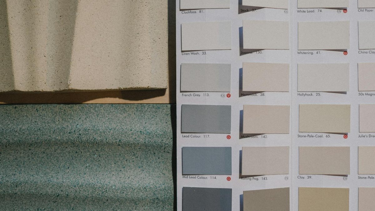 A detailed view of paint color swatches alongside textured material samples for design inspiration.