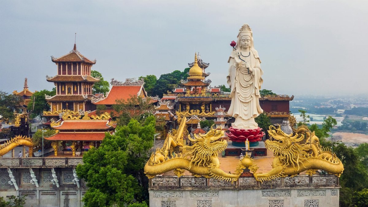 Aerial view showcasing a grand Buddha statue and ornate pagoda in Ho Chi Minh City, Vietnam.