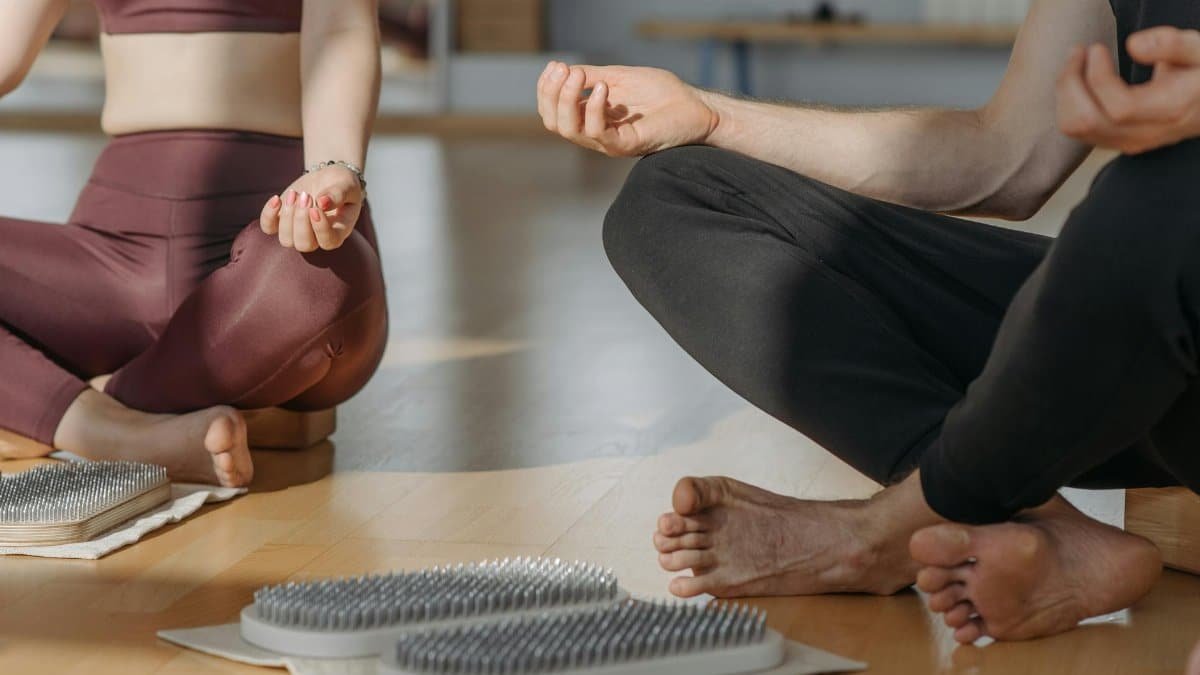 A close-up of people meditating on sadhu boards, promoting relaxation and wellness.