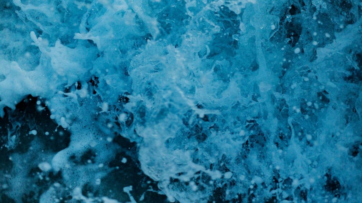 Dynamic close-up of vibrant blue waves crashing, capturing the essence of ocean power and movement.