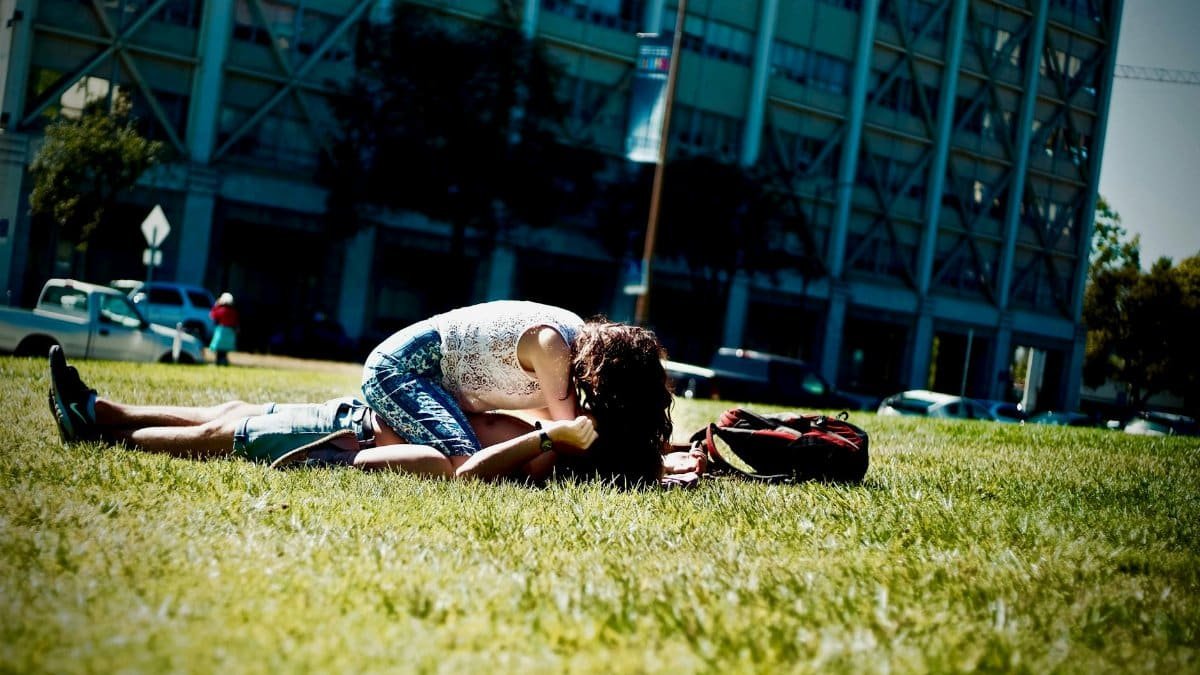 A young couple enjoying a sunny day on a grassy lawn in Berkeley, California.