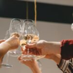 Group of friends celebrating with a toast of wine glasses indoors.